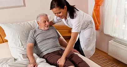 Care Worker with Patient at Bed